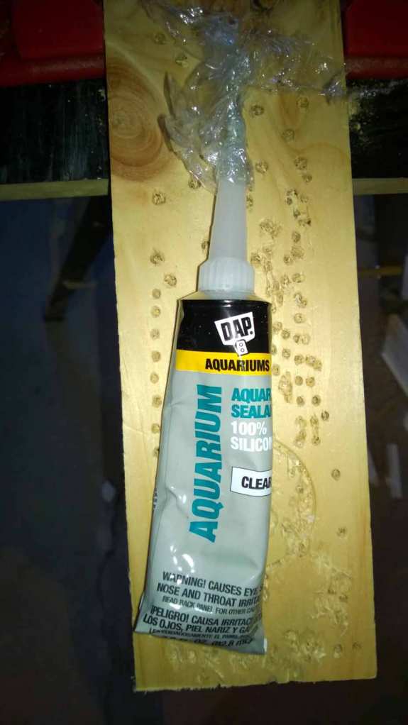 Next, you will need aquarium silicone, which dries non-toxic. For those with hot glue guns, those will work as well.